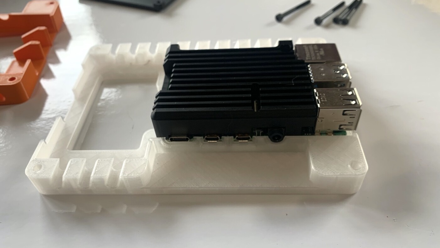 Insert screws that will secure Raspberry Pi